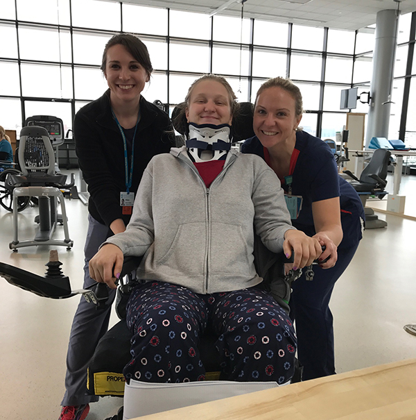 Lily Stilwell with two therapists.